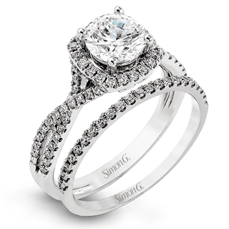 Presenting a lovely twisted shank design, this contemporary white gold engagement ring and wedding band set is accentuated with .44 ctw round cut white diamonds.