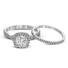 Presenting a lovely twisted shank design, this contemporary white gold engagement ring and wedding band set is accentuated with .44 ctw round cut white diamonds.