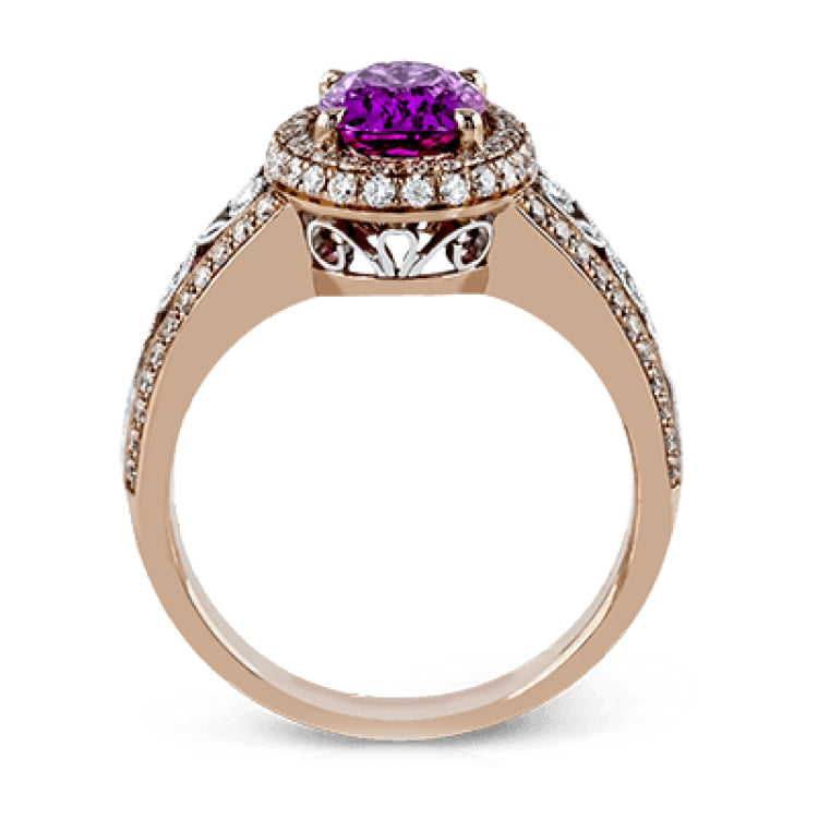 18KWR right hand ring with an intricate design along the shank has a diam halo .55 ctw, and an oval KNZT 5.89 ctw.