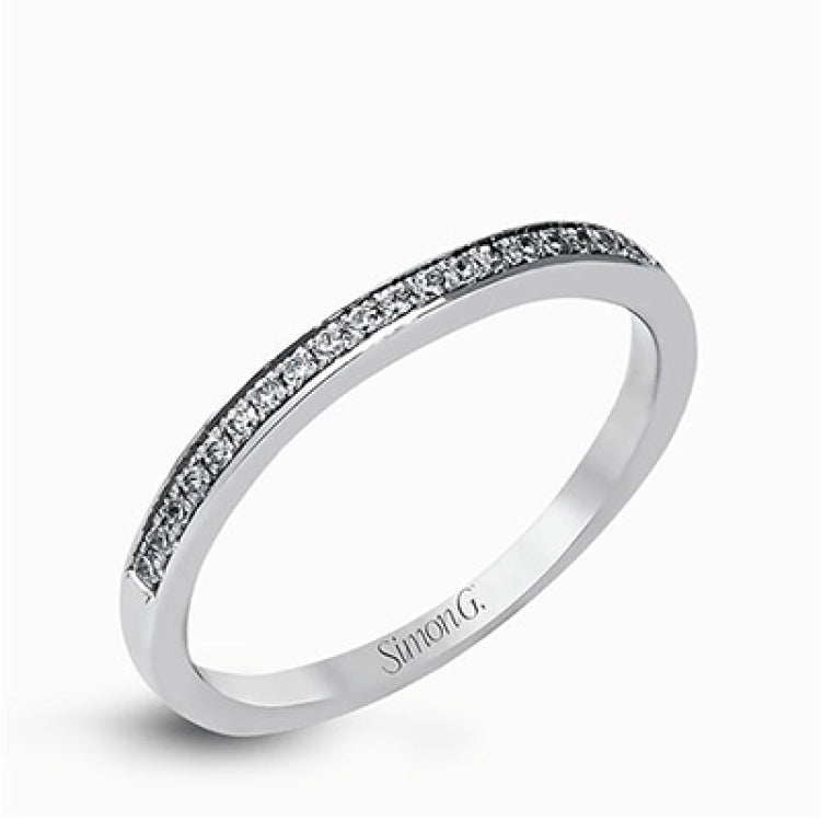 Showcasing a dazzling halo, this contemporary white gold wedding set is highlighted by .45 ctw of arresting round cut white diamonds.