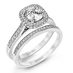Showcasing a dazzling halo, this contemporary white gold wedding set is highlighted by .45 ctw of arresting round cut white diamonds.