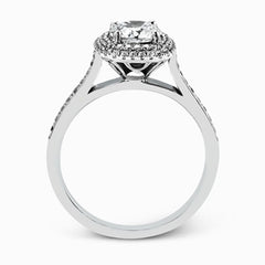 Showcasing a dazzling halo, this contemporary white gold wedding set is highlighted by .45 ctw of arresting round cut white diamonds.