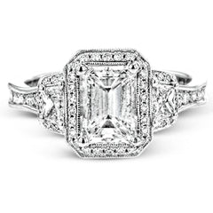 Featuring a lovely romantic setting, this white gold contemporary ring features an exquisite halo and .33 ctw of shimmering round cut white diamonds complemented by .34 ctw of trapezoid side diamonds.