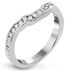 Featuring a lovely romantic setting, this white gold contemporary ring features an exquisite halo and .33 ctw of shimmering round cut white diamonds complemented by .34 ctw of trapezoid side diamonds.