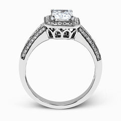 This romantic white gold engagement ring is complemented by .57 ctw of sparkling round cut white diamonds in a vintage-inspired setting.