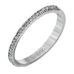Accented by .46 ctw of glistening round cut white diamonds, this contemporary white gold halo style engagement ring and wedding band set makes a dramatic statement.