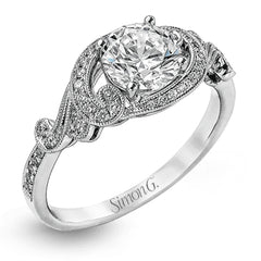 This lovely modern white gold engagement ring features a memorable halo and is accentuated by .19 ctw glistening round cut white diamonds.