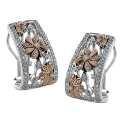 Exquisitely crafted, these two-tone gold earrings feature a lovely floral pattern and contain .74 ctw of white diamonds.