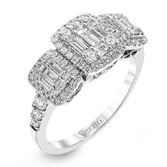 This amazing vintage-inspired ring features three halos and contains .52 ctw of round brilliant diamonds and .41 ctw of baguette diamonds.