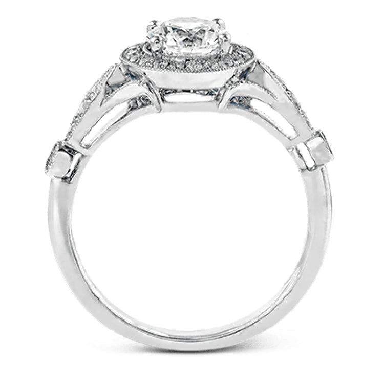 This sparkling white gold vintage inspired engagement ring features an exquisite halo and is set with .25 ctw round cut white diamonds.