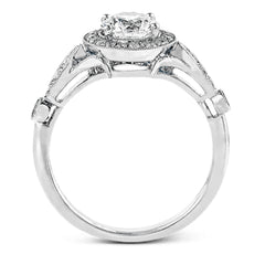 This sparkling white gold vintage inspired engagement ring features an exquisite halo and is set with .25 ctw round cut white diamonds.