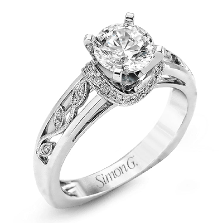 Set with delicate floral patterns, this classic white gold engagement ring is highlighted with .12 ctw round cut white diamonds.
