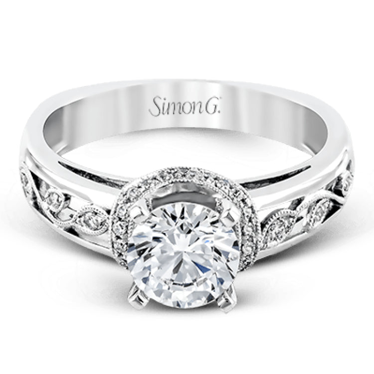 Set with delicate floral patterns, this classic white gold engagement ring is highlighted with .12 ctw round cut white diamonds.