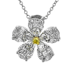 The elegant floral design of this white gold pendant is accentuated by a five petal design with .15 ctw of princess cut diamonds, .48 ctw pear shaped diamonds and .42 ctw marquise cut diamonds.