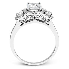 This dramatic contemporary white gold ring is accentuated by .37 ctw round cut white diamonds and features .30 ctw glimmering side stones.