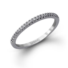 Featuring a distinctively romantic design, this white gold engagement ring and band are set with .22 ctw of round cut white diamonds, .09 ctw of marquise cut diamonds, and .13 ctw pear-shaped diamonds.