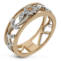 This impressive white and rose gold band is highlighted by a vintage style floral design inset with .09 ctw round cut white diamonds and .01 ctw round cut pink diamonds.