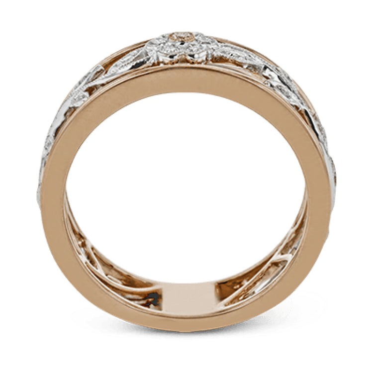 This impressive white and rose gold band is highlighted by a vintage style floral design inset with .09 ctw round cut white diamonds and .01 ctw round cut pink diamonds.