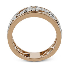 This impressive white and rose gold band is highlighted by a vintage style floral design inset with .09 ctw round cut white diamonds and .01 ctw round cut pink diamonds.
