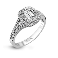 This show-stopping white gold ring features intricately detailed halo and sides containing a total of .61 ctw in round white diamonds.