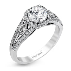 This elegant white gold ring features a lovely vintage style accentuated by .27 ctw of round cut white diamonds and .11 ctw of kite shaped diamonds.