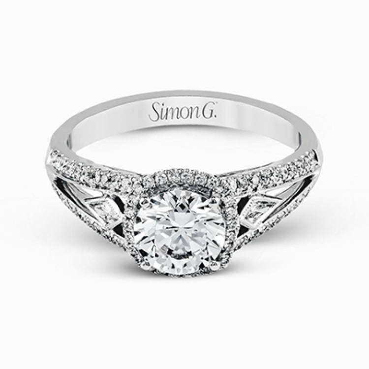 This elegant white gold ring features a lovely vintage style accentuated by .27 ctw of round cut white diamonds and .11 ctw of kite shaped diamonds.