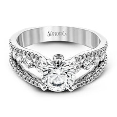 The lovely vintage style of this white gold engagement ring is further enhanced by .91 ctw of shimmering round cut diamonds.