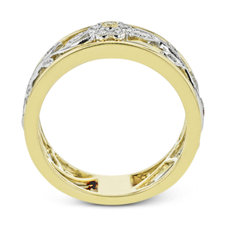 Reflecting a charming vintage floral design, this white and yellow gold band is accentuated by .09 ctw round cut white diamonds and .01 ctw round cut yellow diamonds.