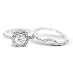 Classy and elegant, this contemporary white gold halo engagement ring and wedding band set is set with .34 ctw of round cut white diamonds.