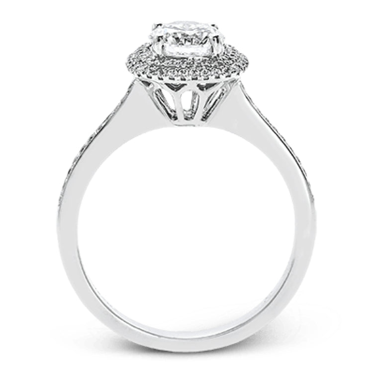 Classy and elegant, this contemporary white gold halo engagement ring and wedding band set is set with .34 ctw of round cut white diamonds.