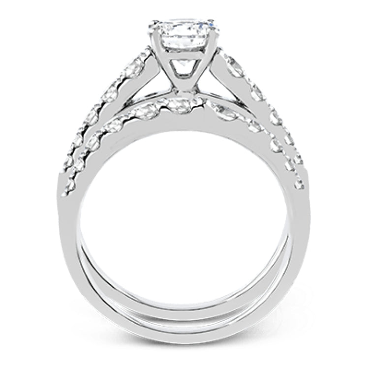 Elevating a classic design with modern elements, this exquisite white gold engagement ring and band are emphasized by .77 ctw of sparkling round cut white diamonds.