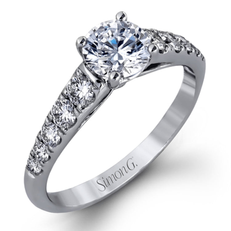 Elevating a classic design with modern elements, this exquisite white gold engagement ring and band are emphasized by .77 ctw of sparkling round cut white diamonds.