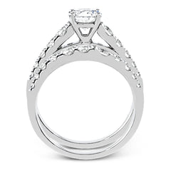 Elevating a classic design with modern elements, this exquisite white gold engagement ring and band are emphasized by .77 ctw of sparkling round cut white diamonds.