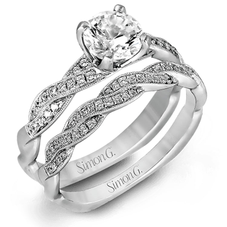 Featuring a modern design, this elegant white gold engagement ring and wedding band set are accentuated by .22 ctw of shimmering round cut white diamonds.