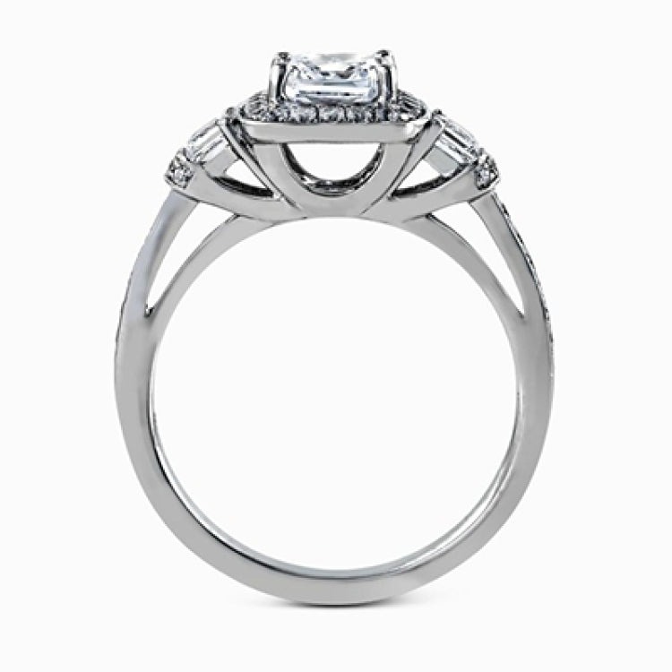 Featuring an intricate design, this white gold engagement ring is emphasized by .26 ctw of round cut white diamonds and .23 ctw of shimmering princess cut white diamonds.