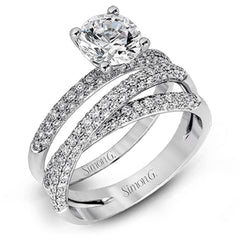 This impressive contemporary white gold engagement ring and wedding band set are emphasized by 1.00 ctw of dazzling round cut white diamonds.
