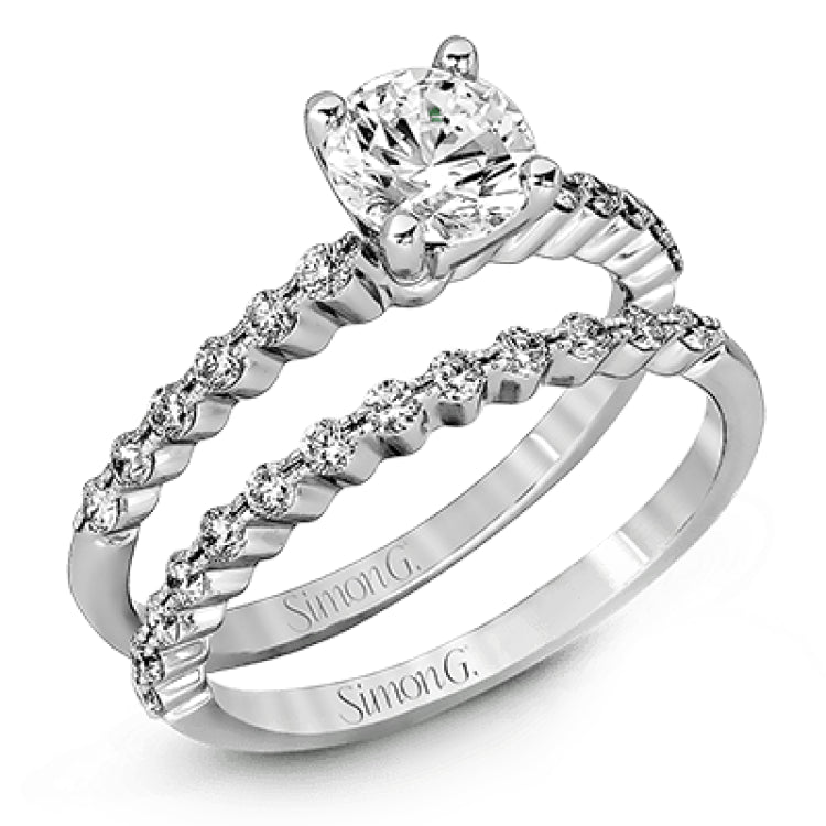 Featuring a charming classic design, this white gold engagement set is accented by .48 ctw of glistening round cut white diamonds.