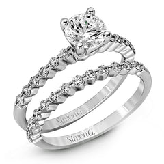 Featuring a charming classic design, this white gold engagement set is accented by .48 ctw of glistening round cut white diamonds.