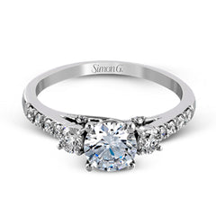 This classic three-stone engagement ring features .24 ctw of round brilliant side stones and .23 ctw of white diamonds extending down the sides.