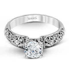 Featuring a delicate floral design, this white gold vintage engagement ring is set with .35 ctw of shimmering white diamonds.