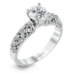 Featuring a delicate floral design, this white gold vintage engagement ring is set with .35 ctw of shimmering white diamonds.