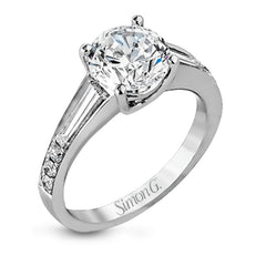 Contemporary in its design, this white gold engagement ring features .17 ctw of round cut white diamonds highlighted by .50 ctw of tapered baguette cut side diamonds.