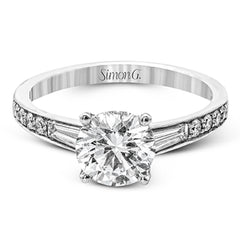 Contemporary in its design, this white gold engagement ring features .17 ctw of round cut white diamonds highlighted by .50 ctw of tapered baguette cut side diamonds.