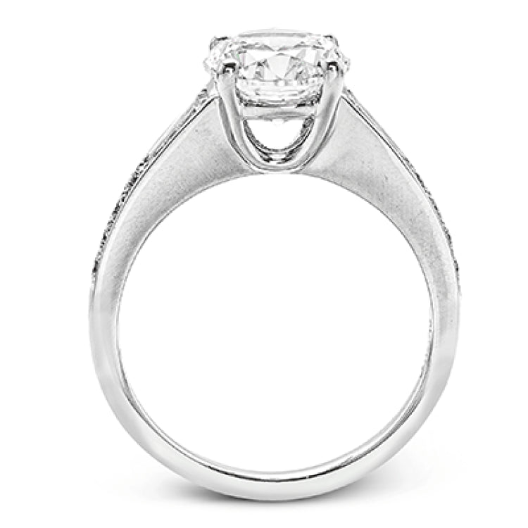 Contemporary in its design, this white gold engagement ring features .17 ctw of round cut white diamonds highlighted by .50 ctw of tapered baguette cut side diamonds.