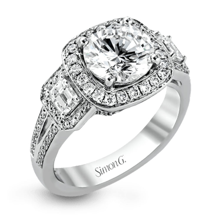 The dazzling contemporary design of this white gold engagement ring is emphasized by .44 ctw round cut white diamonds and .45 ctw emerald cut white diamonds.