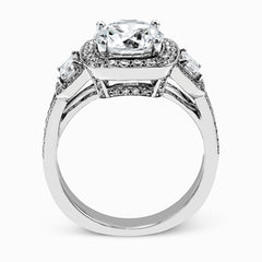 The dazzling contemporary design of this white gold engagement ring is emphasized by .44 ctw round cut white diamonds and .45 ctw emerald cut white diamonds.