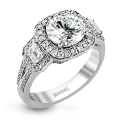 The dazzling contemporary design of this white gold engagement ring is emphasized by .44 ctw round cut white diamonds and .45 ctw emerald cut white diamonds.