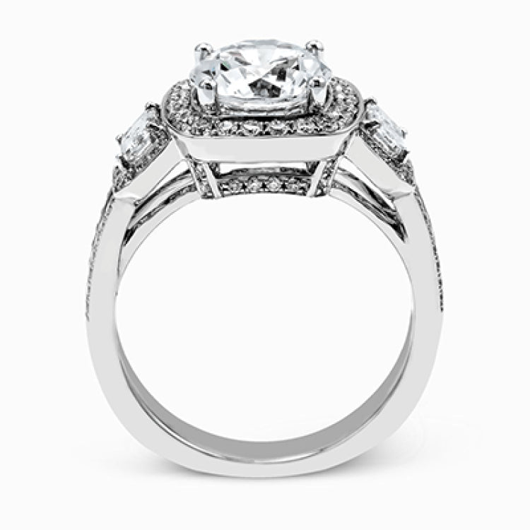 The dazzling contemporary design of this white gold engagement ring is emphasized by .44 ctw round cut white diamonds and .45 ctw emerald cut white diamonds.