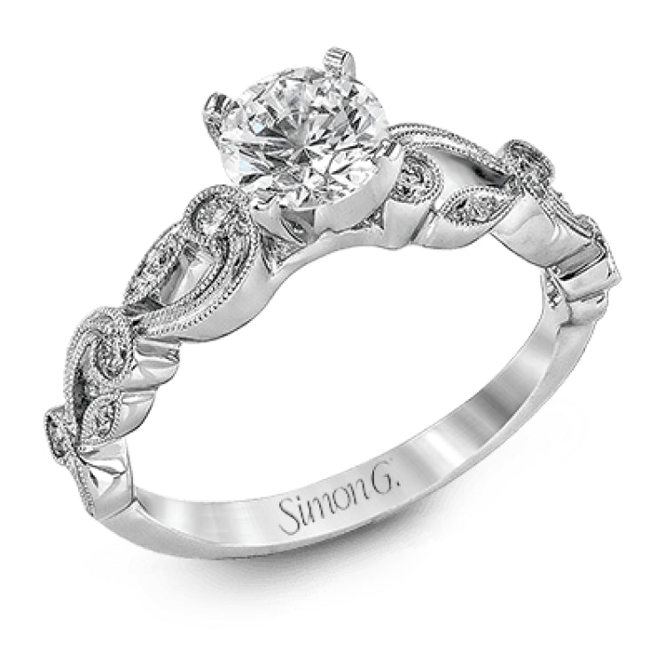 This delicate floral inspired white gold engagement ring and wedding band set is accentuated with .28 ctw shimmering round cut white diamonds.