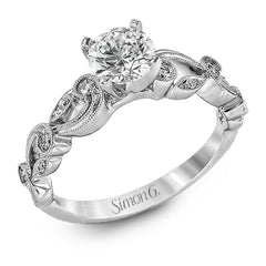 This delicate floral inspired white gold engagement ring and wedding band set is accentuated with .28 ctw shimmering round cut white diamonds.